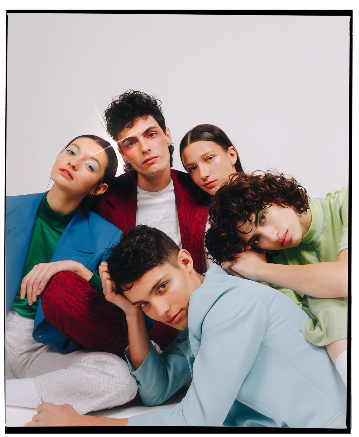 Five models in colorful suits on a white set, Civiles Models Agency
