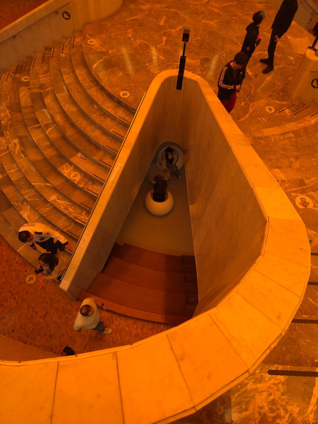 Spiral marble staircase in amber light