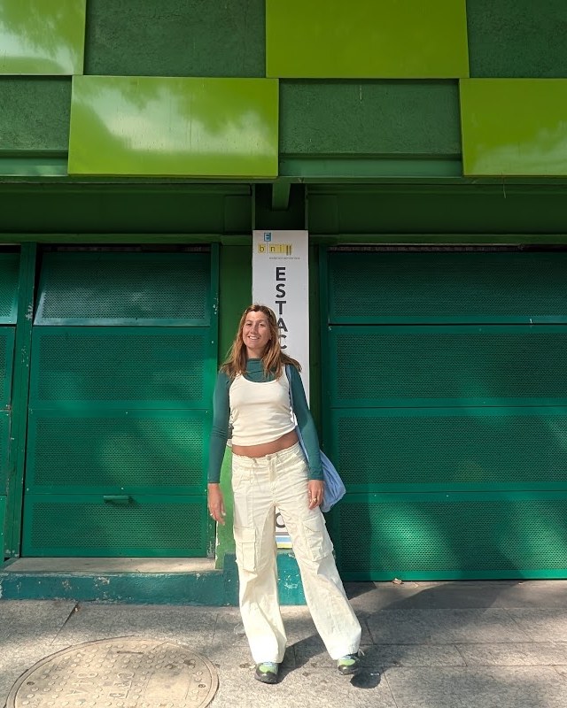 Julia Meilinger in front of a green checkered facade
