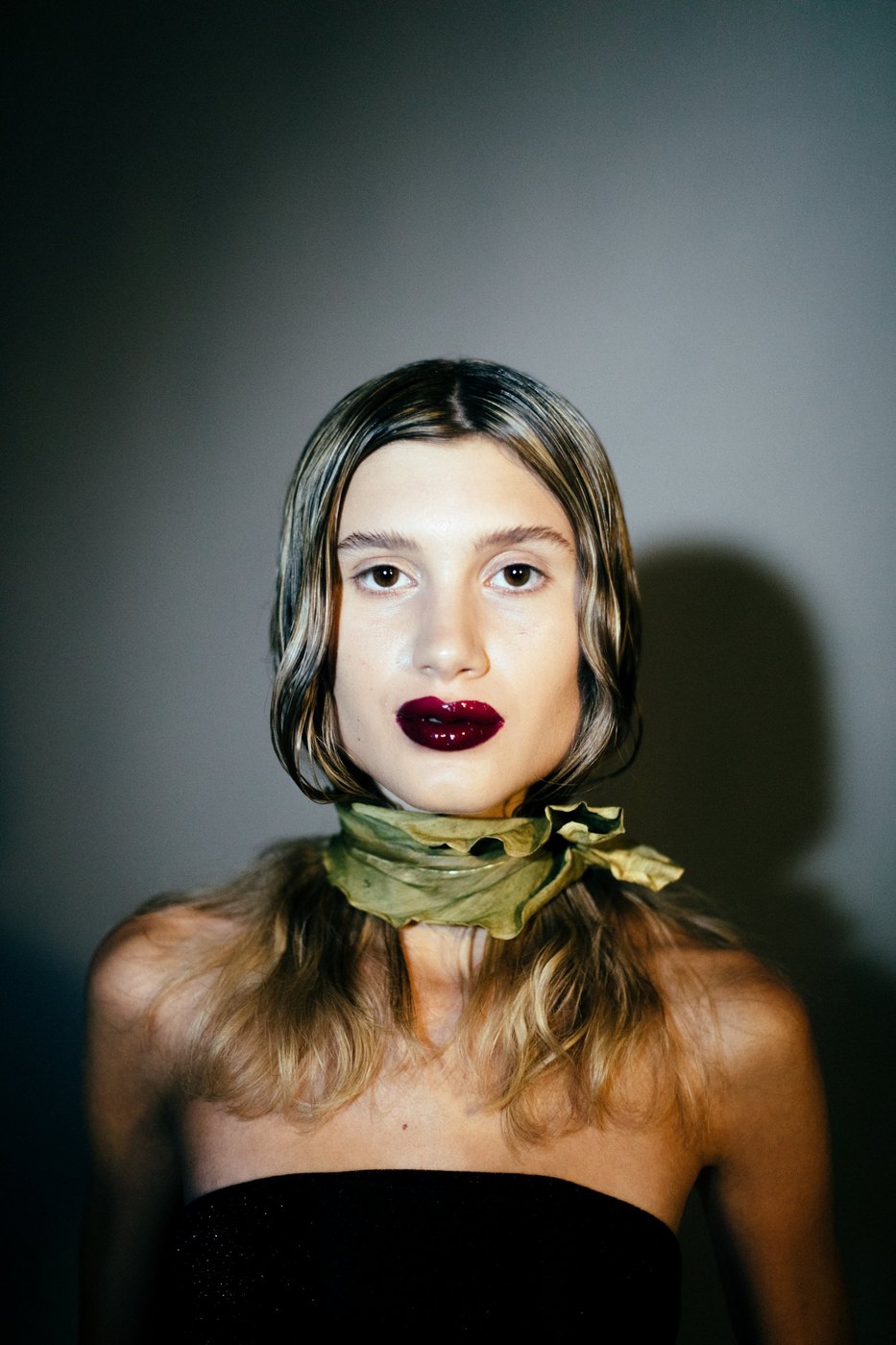 Portrait with a dried green leaf tied as a scarf