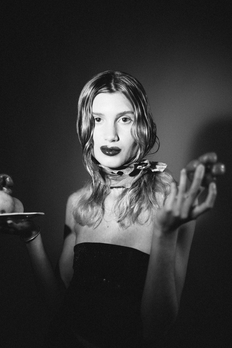 Black and white portrait holding fruit