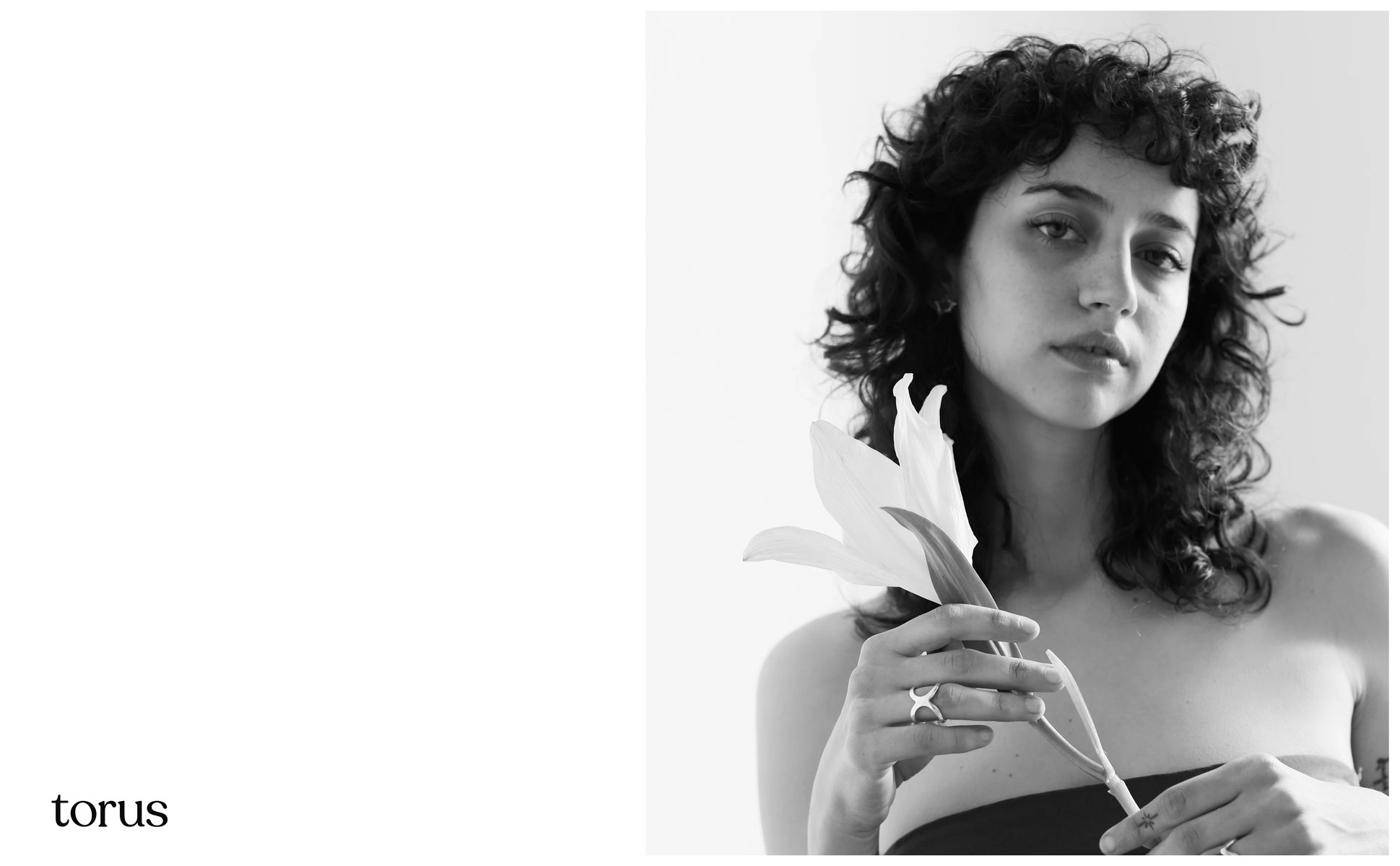 Two models sharing a lemon branch, wearing Torus earrings and cuffs